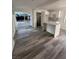 View of living area with sleek wood floors, island, and sliding doors to the backyard at 321 Beaumont St, Las Vegas, NV 89106