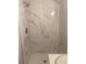 Bathroom shower featuring white and gray marble-patterned tiling and rainfall shower head at 321 Beaumont St, Las Vegas, NV 89106