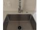 Close-up of a stainless steel kitchen sink with a modern faucet and bright countertops at 321 Beaumont St, Las Vegas, NV 89106
