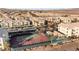 A high angle view of a condo complex with multiple buildings, covered parking, a pool and tennis courts with desert landscape views at 3550 Bay Sands Dr # 1003, Laughlin, NV 89029