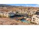 A high angle view of a condo complex with multiple buildings, covered parking, a pool and tennis courts with desert landscape views at 3550 Bay Sands Dr # 1003, Laughlin, NV 89029