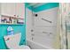 The bathroom with blue accent wall features a shower and tub combination with white tiled walls at 3550 Bay Sands Dr # 1003, Laughlin, NV 89029