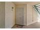 Apartment front door with security screen, colorful welcome mat, and textured stucco wall at 3550 Bay Sands Dr # 1003, Laughlin, NV 89029