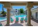 Inviting pool area with lounge chairs framed by elegant pillars and beautiful landscaping at 3550 Bay Sands Dr # 1003, Laughlin, NV 89029