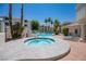 Community pool and hot tub area with lounge chairs and tropical landscaping at 3550 Bay Sands Dr # 1003, Laughlin, NV 89029