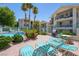 Community pool with lounge chairs, grill, and lush landscaping, creating a relaxing outdoor oasis at 3550 Bay Sands Dr # 1003, Laughlin, NV 89029