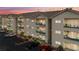 Inviting condo building with tan siding and balconies with decorative railings, surrounded by lush greenery and ample parking at 3550 Bay Sands Dr # 2101, Laughlin, NV 89029