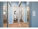 Hallway with mirrored closet doors showing access to bathroom and rooms beyond at 3550 Bay Sands Dr # 2101, Laughlin, NV 89029