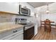 Modern kitchen with stainless steel appliances and a cozy breakfast nook with a hanging light fixture at 3550 Bay Sands Dr # 2101, Laughlin, NV 89029