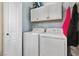 Laundry room with a white washer and dryer, and white upper cabinets at 3550 Bay Sands Dr # 2101, Laughlin, NV 89029
