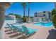 Community pool and hot tub surrounded by lounge chairs and palm trees at 3550 Bay Sands Dr # 2101, Laughlin, NV 89029