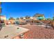 Spacious backyard with a trampoline, dining set under an umbrella, and gravel landscape at 3592 Gloucester Gate St, Las Vegas, NV 89122