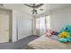 Bright bedroom featuring a ceiling fan, closet, plush carpeting, and natural light at 3592 Gloucester Gate St, Las Vegas, NV 89122