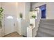 Bright entryway featuring a staircase with decorative shelving and a white front door at 3592 Gloucester Gate St, Las Vegas, NV 89122