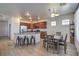 Open kitchen and dining area with stainless steel appliances and a breakfast bar with modern black barstools at 3592 Gloucester Gate St, Las Vegas, NV 89122