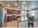 Well-equipped kitchen featuring stainless steel appliances, wooden cabinets, and bar stool seating at 3592 Gloucester Gate St, Las Vegas, NV 89122