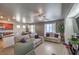 Open-concept living room with hardwood floors, a ceiling fan, and seamless flow to the kitchen at 3592 Gloucester Gate St, Las Vegas, NV 89122