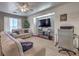 Cozy living room with a large TV, comfortable seating, and bright natural light at 3592 Gloucester Gate St, Las Vegas, NV 89122