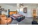 Well-lit bedroom with ceiling fan, comfy chair, and ample closet space at 3592 Gloucester Gate St, Las Vegas, NV 89122