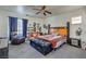 Comfortable main bedroom features a ceiling fan, large window, and a sitting area with a leather chair at 3592 Gloucester Gate St, Las Vegas, NV 89122