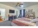 Inviting bedroom with ceiling fan, large television, and comfortable seating area at 3592 Gloucester Gate St, Las Vegas, NV 89122