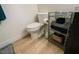 Well-maintained bathroom with a toilet, dark shelves, storage and essential toiletries at 3789 Heritage Ave, Las Vegas, NV 89121
