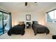 Comfortable bedroom featuring two twin beds, a ceiling fan, and a sliding glass door to the patio at 3789 Heritage Ave, Las Vegas, NV 89121