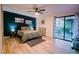 Relaxing bedroom with a king bed, patio access, and a ceiling fan for added comfort at 3789 Heritage Ave, Las Vegas, NV 89121