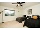 Inviting bedroom with two twin beds, a ceiling fan, and a view of the outdoors at 3789 Heritage Ave, Las Vegas, NV 89121