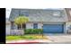 Charming two-story home with a blue front door, complementary blue garage, and a well-manicured green lawn at 3789 Heritage Ave, Las Vegas, NV 89121