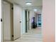 Bright hallway featuring tile floors, sliding mirror closet doors reflecting living room, and white doors and trim at 3789 Heritage Ave, Las Vegas, NV 89121