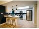 Contemporary kitchen with white cabinets, stainless steel appliances, a skylight, and a breakfast bar at 3789 Heritage Ave, Las Vegas, NV 89121