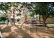 A playground with monkey bars and a slide surrounded by trees in a well-kept community park at 3789 Heritage Ave, Las Vegas, NV 89121