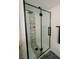 Modern shower with stylish tile accents, black hardware, and sleek glass enclosure at 3789 Heritage Ave, Las Vegas, NV 89121