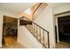 Modern stairway with carpeted steps, dark metal railing, and ample natural light from above at 3789 Heritage Ave, Las Vegas, NV 89121