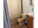 Modest bathroom with tiled floor and light green shower curtain at 4016 Edgeford Pl, Las Vegas, NV 89102