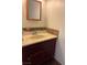 Neutral bathroom with wooden-framed mirror and marble countertop at 4016 Edgeford Pl, Las Vegas, NV 89102