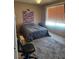 Bedroom with window and patterned accent wall at 4016 Edgeford Pl, Las Vegas, NV 89102