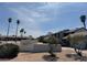 Community exterior with lush, mature landscaping and sunny skies in the background at 4016 Edgeford Pl, Las Vegas, NV 89102