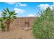 Landscaped backyard featuring a fountain and desert plants against a block wall at 4029 Ricebird Way, North Las Vegas, NV 89084