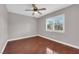 Bright bedroom with hardwood floors, ceiling fan, and a window with plantation shutters at 4029 Ricebird Way, North Las Vegas, NV 89084