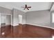 Spacious bedroom with ceiling fan and doorway to bathroom and tile floor at 4029 Ricebird Way, North Las Vegas, NV 89084