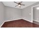 Bedroom featuring ceiling fan, hardwood floors, and closet at 4029 Ricebird Way, North Las Vegas, NV 89084