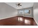 Bright bedroom featuring a ceiling fan, hardwood floor, and a bay window providing natural light at 4029 Ricebird Way, North Las Vegas, NV 89084