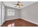 Bedroom featuring hardwood floors, window with blinds, and a ceiling fan at 4029 Ricebird Way, North Las Vegas, NV 89084