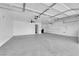 Spacious three-car garage with high ceilings, ceiling fans, and built-in shelving at 4029 Ricebird Way, North Las Vegas, NV 89084