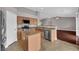 Open kitchen with stainless appliances and an island, seamlessly flowing into the living area at 4029 Ricebird Way, North Las Vegas, NV 89084