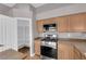 Bright kitchen with stainless steel stove and convenient pantry with shelving at 4029 Ricebird Way, North Las Vegas, NV 89084