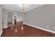 Bright living room featuring hardwood floors, chandelier, and view into dining and fireplace rooms at 4029 Ricebird Way, North Las Vegas, NV 89084