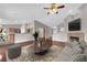 Bright living room with modern furnishings, fireplace, and seamless flow into the kitchen area, perfect for entertaining at 4029 Ricebird Way, North Las Vegas, NV 89084